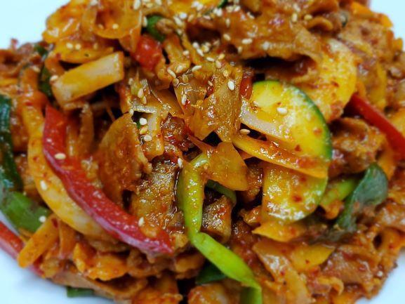 Jae Yook Bokkeum · Stir fried sliced spicy marinated Berkshire pork shoulder with scallions, onions, peppers, and zucchini.  Very popular item.