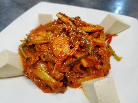 Jae Yook Kimchi Bokkeum · Sautee spicy Berkshire pork shoulder and kimchi in a sweet and spicy sauce garnished with fresh steamed tofu. Spicy.