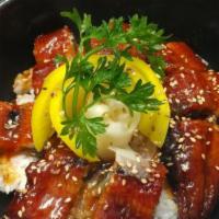 Jang Uh Dup Bap · Broiled marinated eel with special sauce cooked over crisped rice in a stone bowl, garnished...