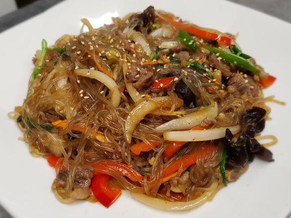 Jap Chae · Stir fried glass vermicelli noodles with vegetables, assorted mushrooms and tender morsels of beef.  Seafood option available. Spicy or Not Spicy. Very popular item.