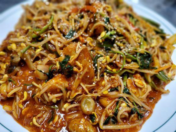 Agu Jjim · Monkfish pieces on the bone simmered with soy bean sprouts and minari (Korean parsely) in a spicy sauce.  Great for sharing with 2 or more people.
