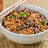 Fried Rice · Stir fried rice with egg, carrots, broccoli, and scallions mixed in a savory brown sauce.