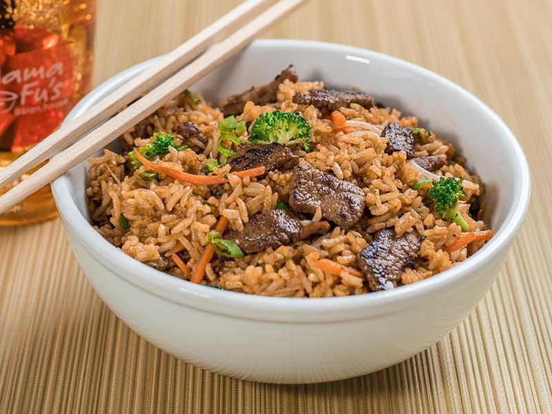 Fried Rice · Stir fried rice with egg, carrots, broccoli, and scallions mixed in a savory brown sauce.