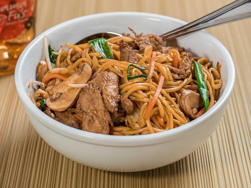 Lo Mein · Wheat noodles in a savory garlic brown sauce with mushrooms, cabbage, carrots, onions, and scallions.