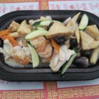 84. Sizzling Seafood Plate · Prawns, scallops, chicken, fried tofu and vegetables served in white wine sauce on a hot pla...