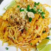 Mee Goreng · Wok tossed yellow noodle dish in sweet and savory red sauce with fried tofu, onions, bean sp...