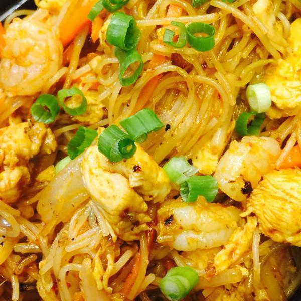 Singapore Rice Noodle · Stir fried thin rice noodles with bean sprouts, onions, peapods, cabbage, carrots and egg tossed in yellow curry seasoning. Hot and spicy.
