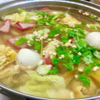 9. Wonton Soup · Wonton skin stuffed with ground pork, vegetable, fish ball and BBQ pork in clear broth.