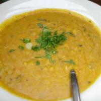 24. Tarka Dall · Red lentils cooked with onions, tomatoes and herbs.