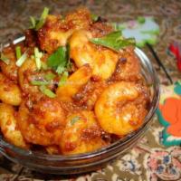 54. Shrimp Jhalfrize · Prepared with sauteed onion, green chili pepper, tomatoes and fairly dry curry sauce.