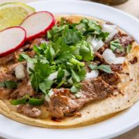 Steak Taco · Grilled chopped tender steak. Served on a warm tortilla finished with freshly cut white onio...