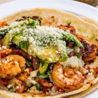 Grilled Shrimp Taco · Marinated shrimp served on soft corn tortilla and topped with pico de gallo and chipotle sau...