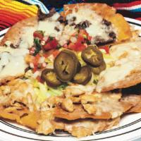 Nachos DLX · Crispy corn tortillas coated with refried beans and melted Monterrey cheese. Served with rom...