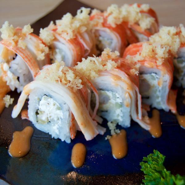 Shaggy Roll · Shrimp tempura, cucumber, cream cheese, and crab meat. Topped with crunch and spicy mayo.