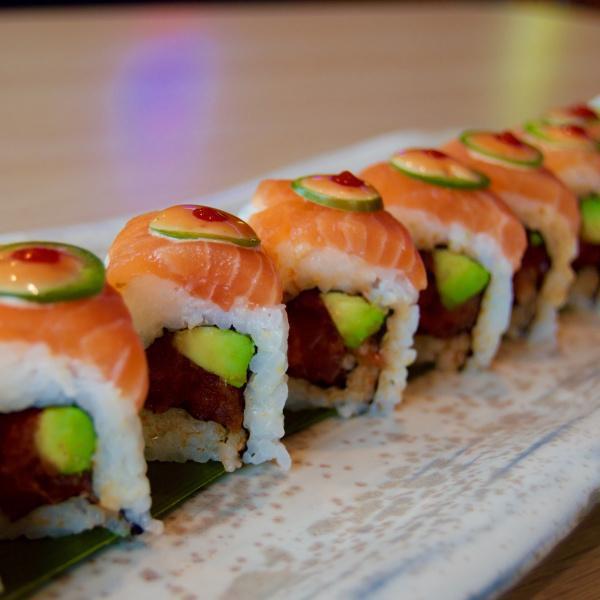 1960 Roll · Spicy tuna inside. Topped with fresh salmon, jalapeno, sriracha, and spicy mayo.