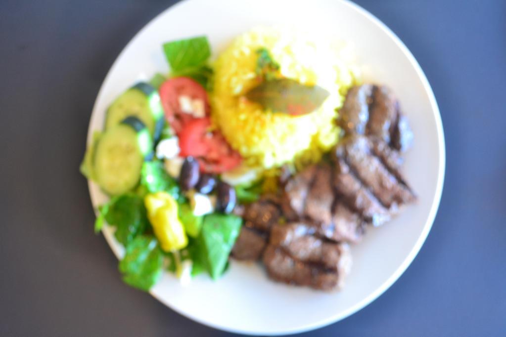 Shish Kabob Plate · Lean cuts of marinated charbroiled cubes of tender beef. Served with basmati yellow rice, Greek salad, warm pita.