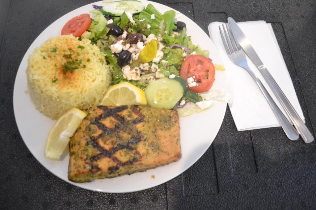 Grilled Salmon Platter · Char-grilled wild salmon with Mediterranean spices. Served with basmati rice, Greek salad, warm pita and choice of your sauce.