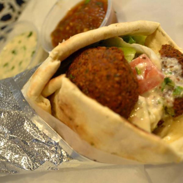 falafel Vegetarian Wrap · Hummus, falafel, tabbouleh  served in a heated pita. Served on warm pita bread with lettuce, tomatoes and choice of sauce.