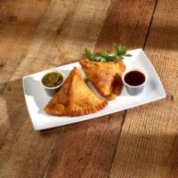 Meat Samosa · Crispy pastry shell stuffed with mildly spiced ground lamb and peas.