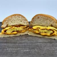 Signature Breakfast Sandwich · Scrambled Eggs and Bacon folded together with Swiss Cheese on a Grilled Kaiser Roll.