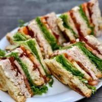 Turkey Club · Roasted Turkey, Crispy Bacon, Lettuce, Tomato and Mayo stacked between three layers of Toast...