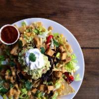 Fiesta Nachos · black beans. house-made chips. iceberg. tomatoes. roasted red bell peppers. jalapeños. grill...