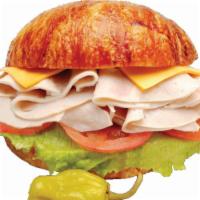 Turkey and Cheese on Croissant · Served with turkey, lettuce, tomatoes,cheese  mayonnaise, on side onions, dill pickle, peppe...