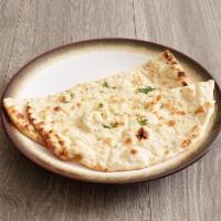 Garlic Naan · Naan stuffed with garlic, paneer, cilantro and spices with butter brushed on top. Most popul...