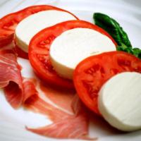 2. Tomato and Mozzarella Salad · Homemade mozzarella with prosciutto and tomatoes, imported olive oil and basil.