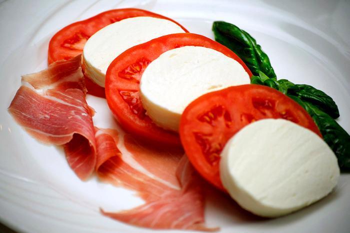 2. Tomato and Mozzarella Salad · Homemade mozzarella with prosciutto and tomatoes, imported olive oil and basil.