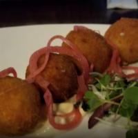 Goat Cheese Croquette Bites · Served with pickled red onion and garlic aioli. Vegetarian-friendly.