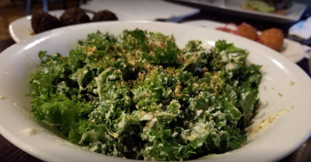 Marinated Kale Caesar Salad · Marinated kale tossed with traditional Caesar dressing and crispy Parmesan crumbles.