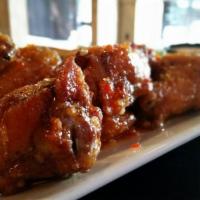 Chicken Wings · Our wings are dry-rubbed and slow roasted before being fried to order. Served with your choi...
