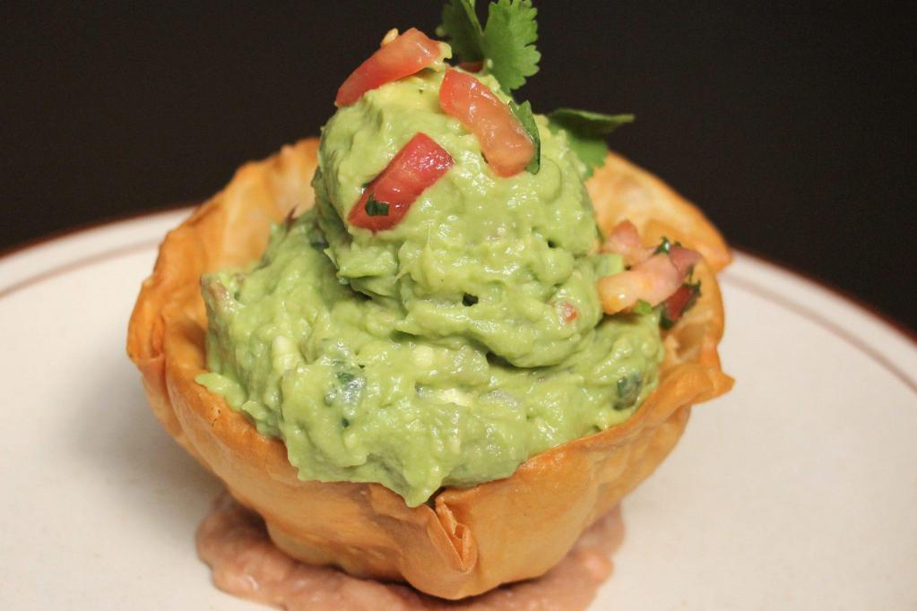 Fresh Guacamole · Ripe avocados mixed with spices, onions, diced tomatoes, lime and cilantro.