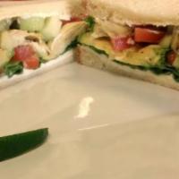 Mediterranean Veggie Supreme Sandwich · on Toasted bread with Hummus, Avocado, marinated artichoke hearts, Spinach, tomatoes, cucumb...