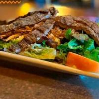 Alegria Salad with Steak · Marinated grilled steak over a bed of spring mix salad, apple slices, bacon bits, shredded c...