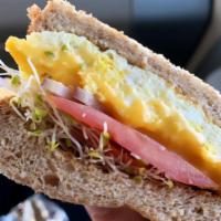 Maya's Delight · Three eggs, American cheese, tomatoes, sprouts, and onions on toasted white bread. Your choi...