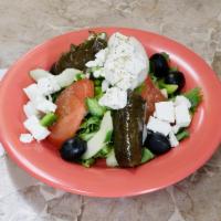 Greek Salad · Feta cheese, Kalamata olives, stuffed grape leaves, onions, tomatoes and green peppers.
