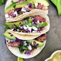 Skirtsteak Tacos · 3 skirtsteak steak tacos 
Served with avocado cracker salad
And pick de gallo and green sauce