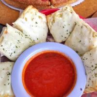 Cheesy Garlic Bread · Buttery garlic bread that is topped with mozzarella cheese & parsley. Served with a side of ...