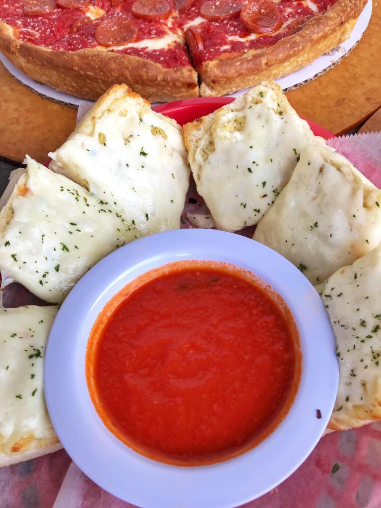 Cheesy Garlic Bread · Buttery garlic bread that is topped with mozzarella cheese & parsley. Served with a side of marinara.