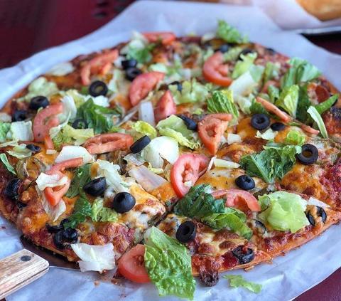 Thin Crust Taco Pizza · Ground beef, pepperoni, black olives, topped with mozzarella and cheddar cheese, lettuce, fresh tomatoes and jalapenos.