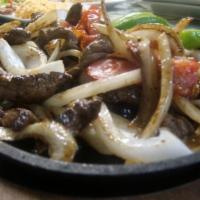 Beef Fajitas Dinner · Hot hot onion tomatoes and jalapenos with beef. Includes beans, rice, lettuce, and your choi...