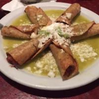 Mini Taquitos · Crispy corn tortilla rolls filled with chicken, beef or potato topped with salsa verde, guac...