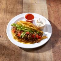 Ground Beef Taco · Just like your mom's. Fresh hot corn tortilla. Includes salsa, lettuce, cheese, hot sauce an...