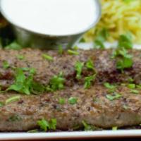 Beef Koobideh · 2-skewers of finely minced beef seasoned with special spices served with basmati rice, house...