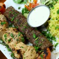 Kabobe-sultani · A skewer of beef koobideh and chicken shish kebab served with basmati rice, house feta salad...