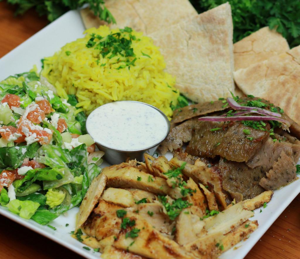 Shawarma Lover Platter · Generous portions of two delicious meat items (chicken, beef shawarma or gyro) roasted on vertical spit served with your choice of two side items, creamy garlic or tzatziki sauce and a warm pita bread.