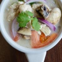 S2. Tom Kar Kai · Coconut milk soup with chicken, mushroom, galanga, tomato and cilantro. Gluten free.