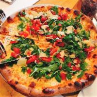 Moderna Pizza · Tomato sauce, mozzarella, diced tomatoes, arugula, and shaved Parmesan cheese.